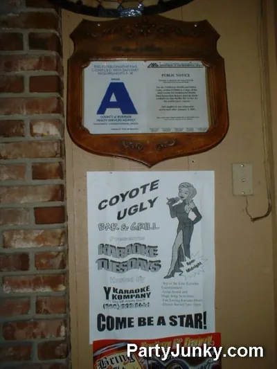 Venue sign and event banner at Coyote Ugly Bar & Grill, May 29, 2004