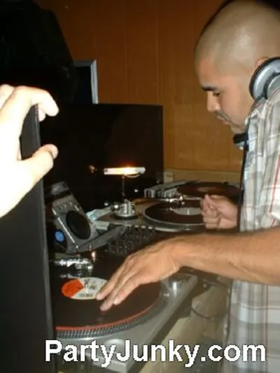 DJ at the turntables at Coyote Ugly Bar & Grill