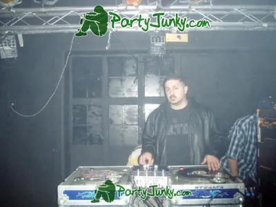 DJ at the turntables at the Suga Free concert, Dec 14, 2003
